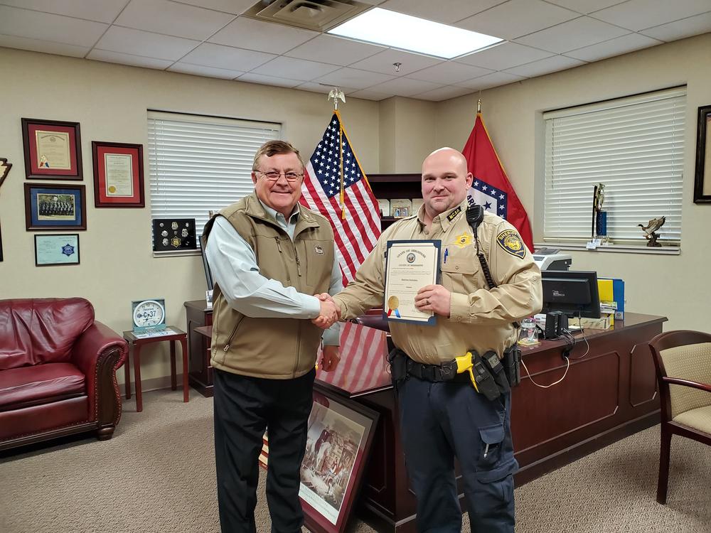 sheriff shaking hands with promoted deputy