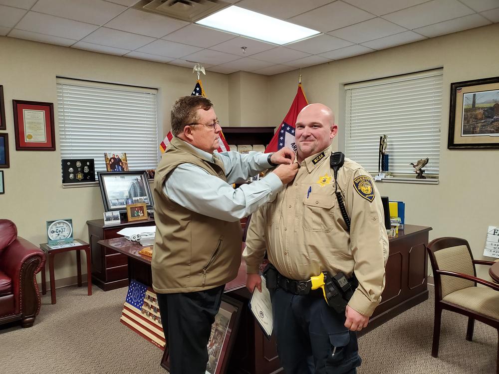 sheriff pinning rank on promoted deputy