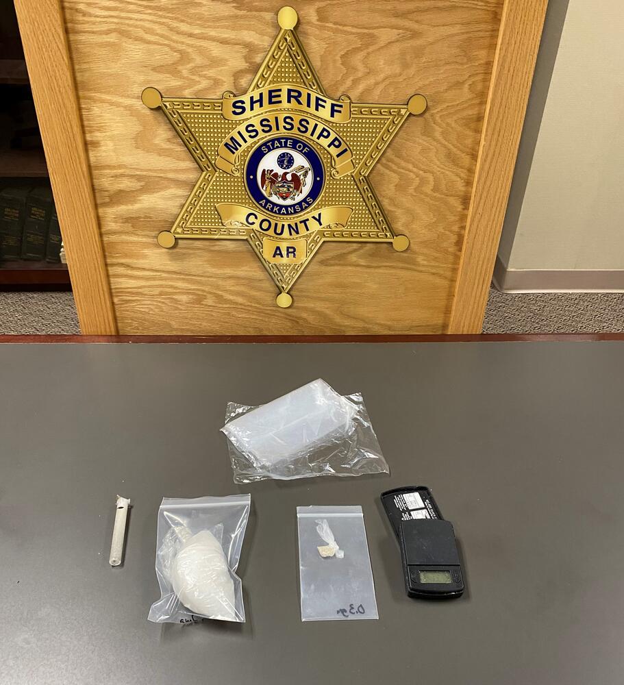 Seized drugs displayed on table.
