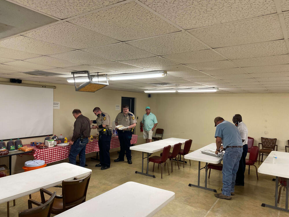 Staff lining up to eat lunch.