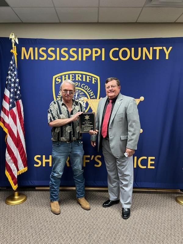 Joe Parsons and Sheriff Cook with retirement certificate. 