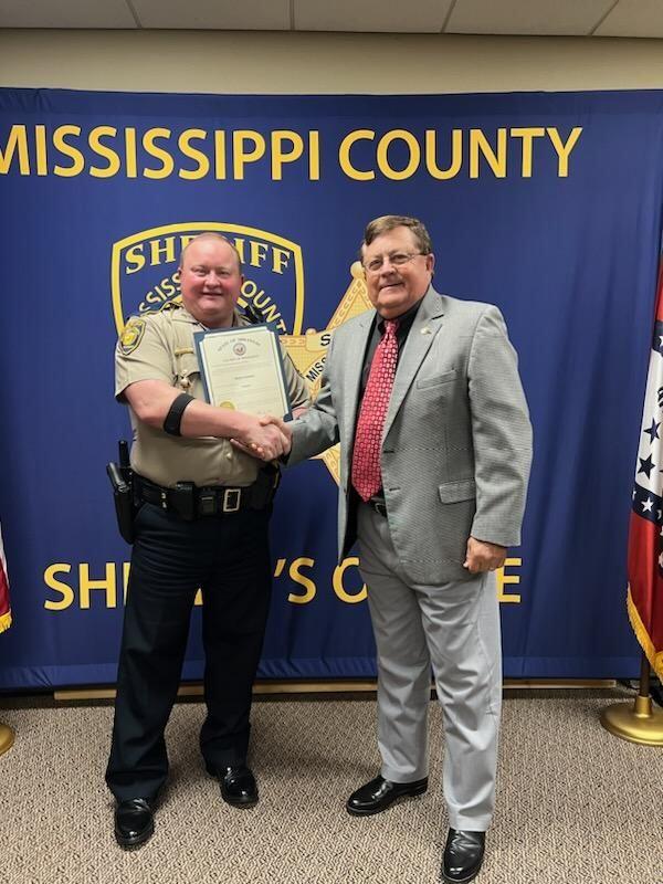 Sergeant Vandyke posing for picture with Sheriff Cook. 