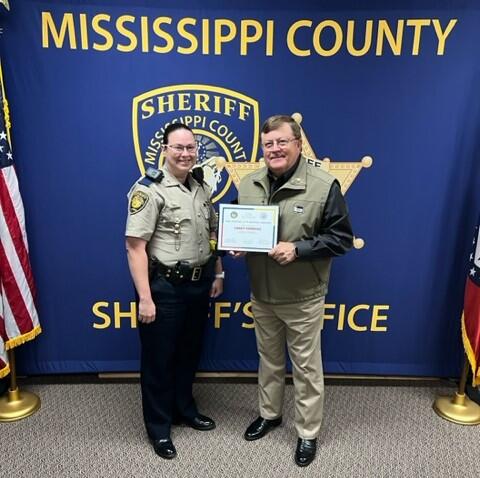 Cpl. Casey Vandyke and Sheriff Cook holding a certificate.