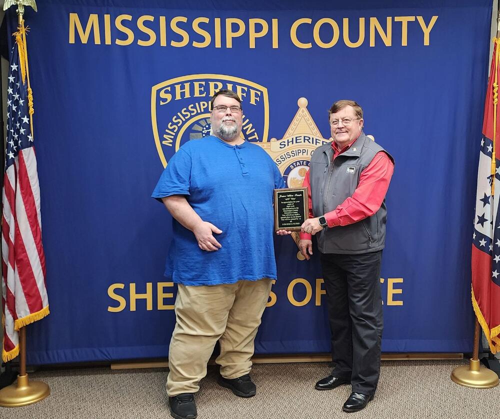 James Franks receiving plaque from Sheriff Cook.