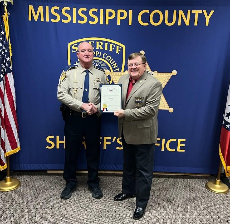 Sgt. Dixon holding a promotion certificate. 