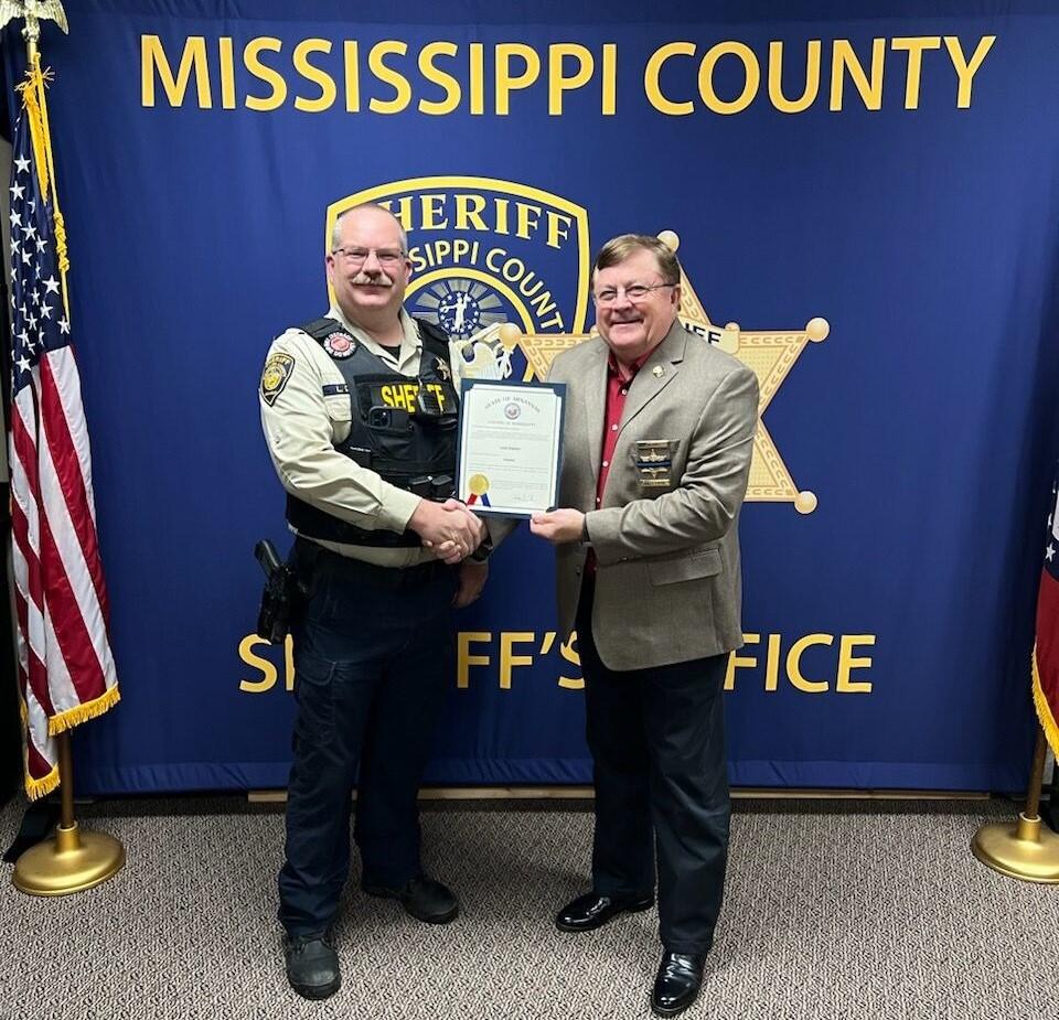 Sgt. Danner holding a promotion certificate. 