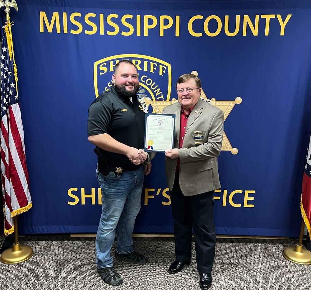 Sgt. Griffin holding a promotion certificate. 