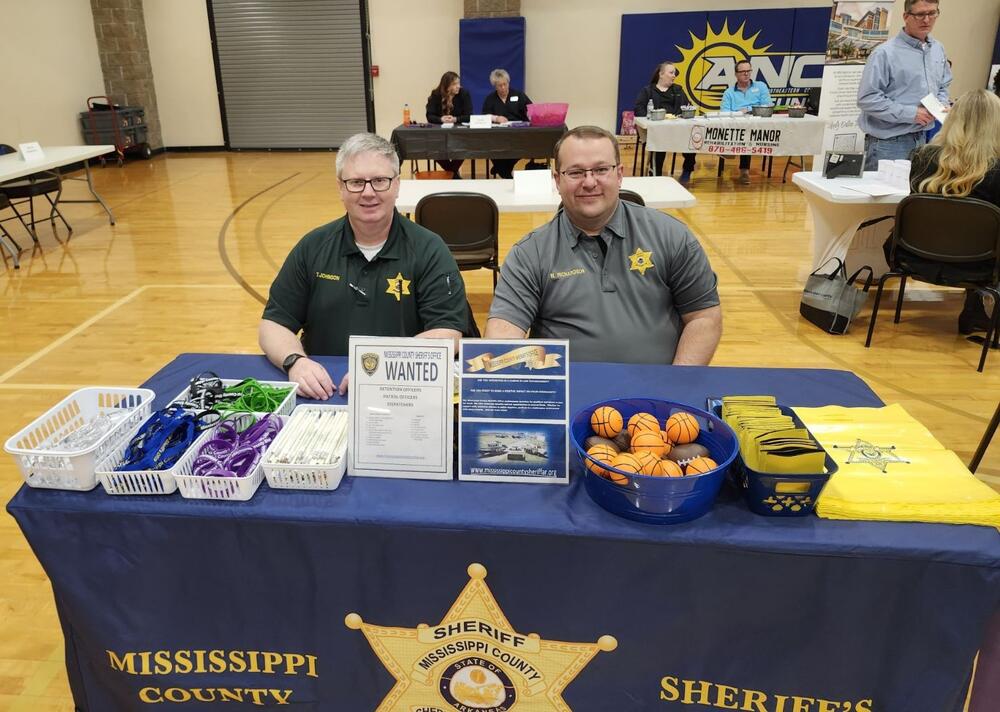 Officers sitting at information desk. 