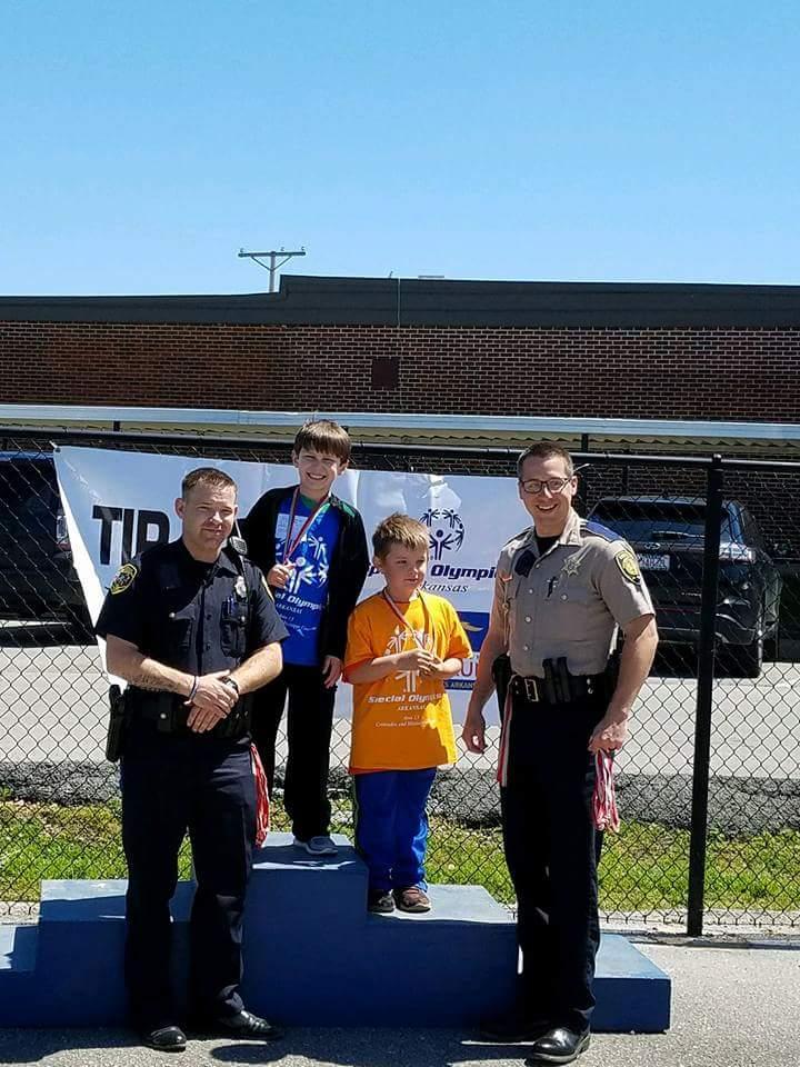 Image of Deputy Matt Malone with local children.