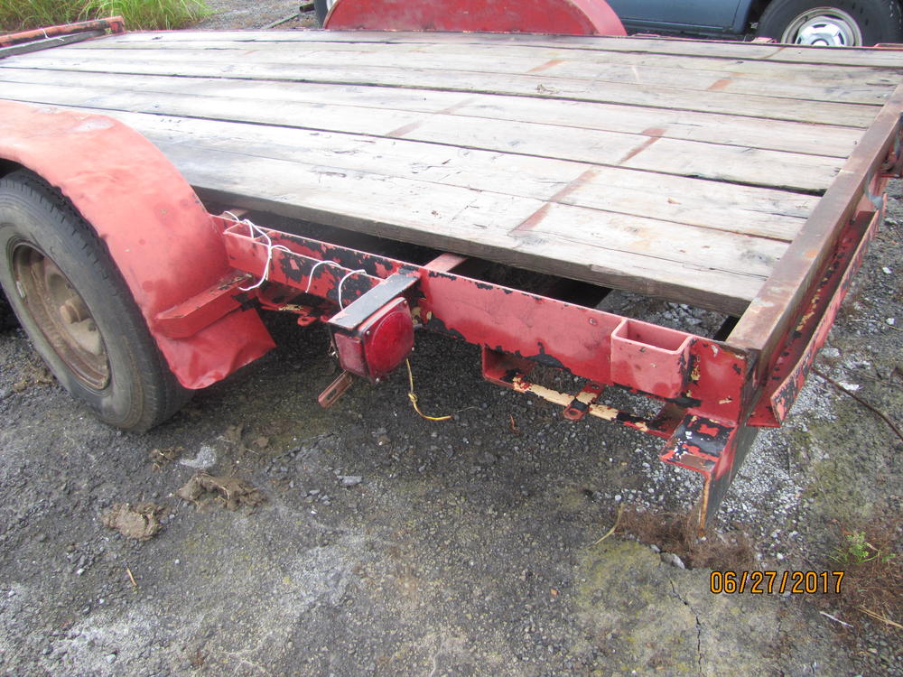 Tail light on a red flat bed trailer.