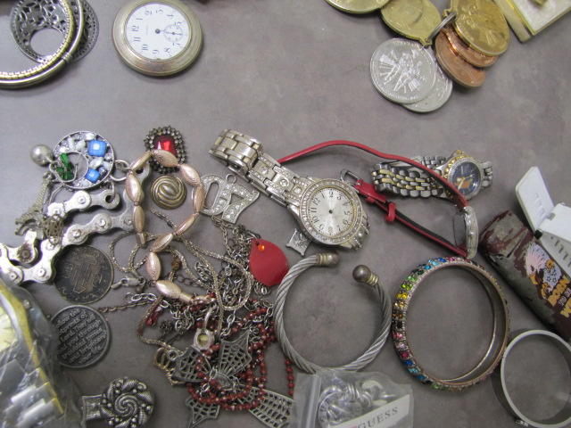 Several silver bracelets and a watch.