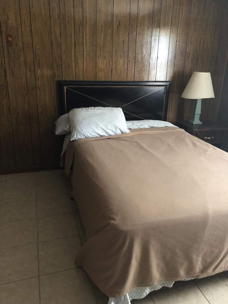 Photo of a brown bed.